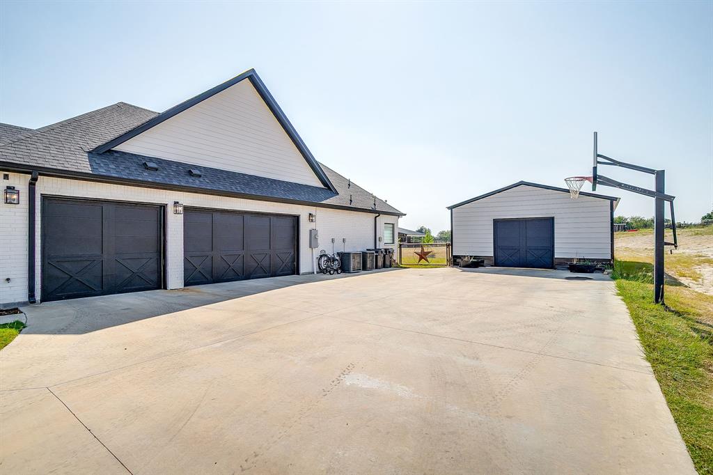 116 Aviara Ridge Road Poolville, TX 76487 - Photo 7 of 38 a front view of a house with a yard and garage