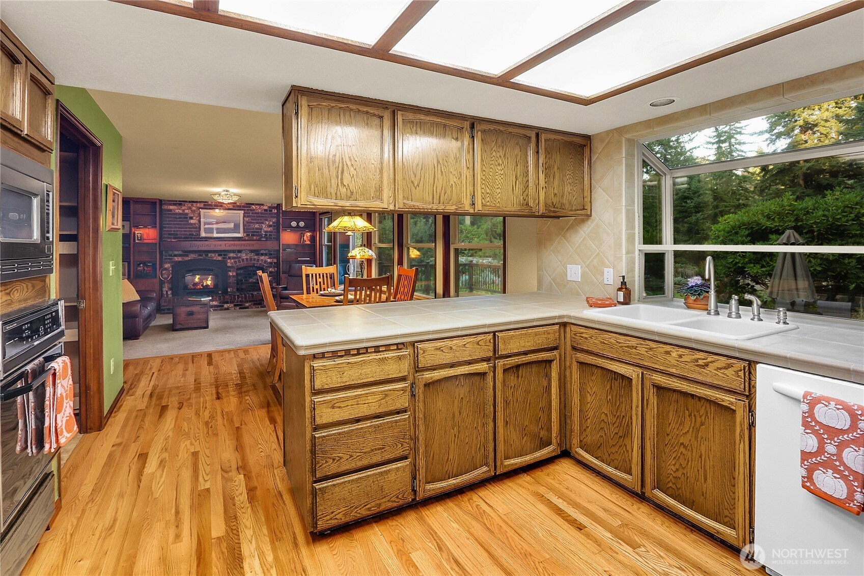 17521 7th Avenue West Bothell, WA 98012 - Photo 11 of 40 a kitchen with stainless steel appliances granite countertop a sink and wooden cabinets