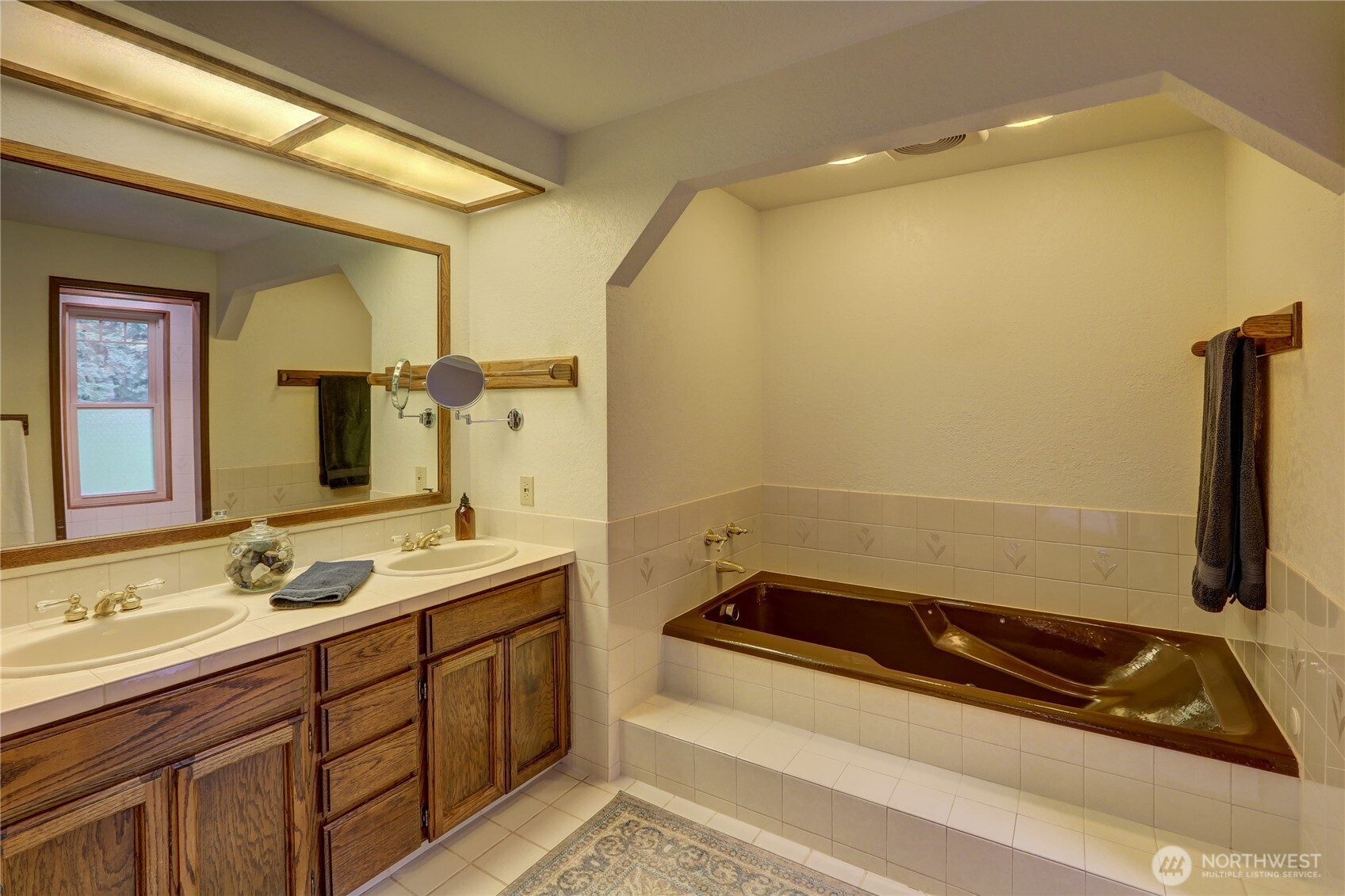 17521 7th Avenue West Bothell, WA 98012 - Photo 23 of 40 a bathroom with a sink a toilet a mirror and bathtub