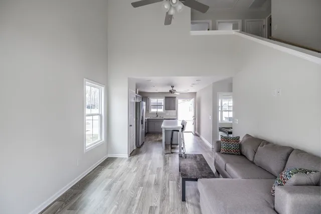 a living room with furniture and a wooden floor