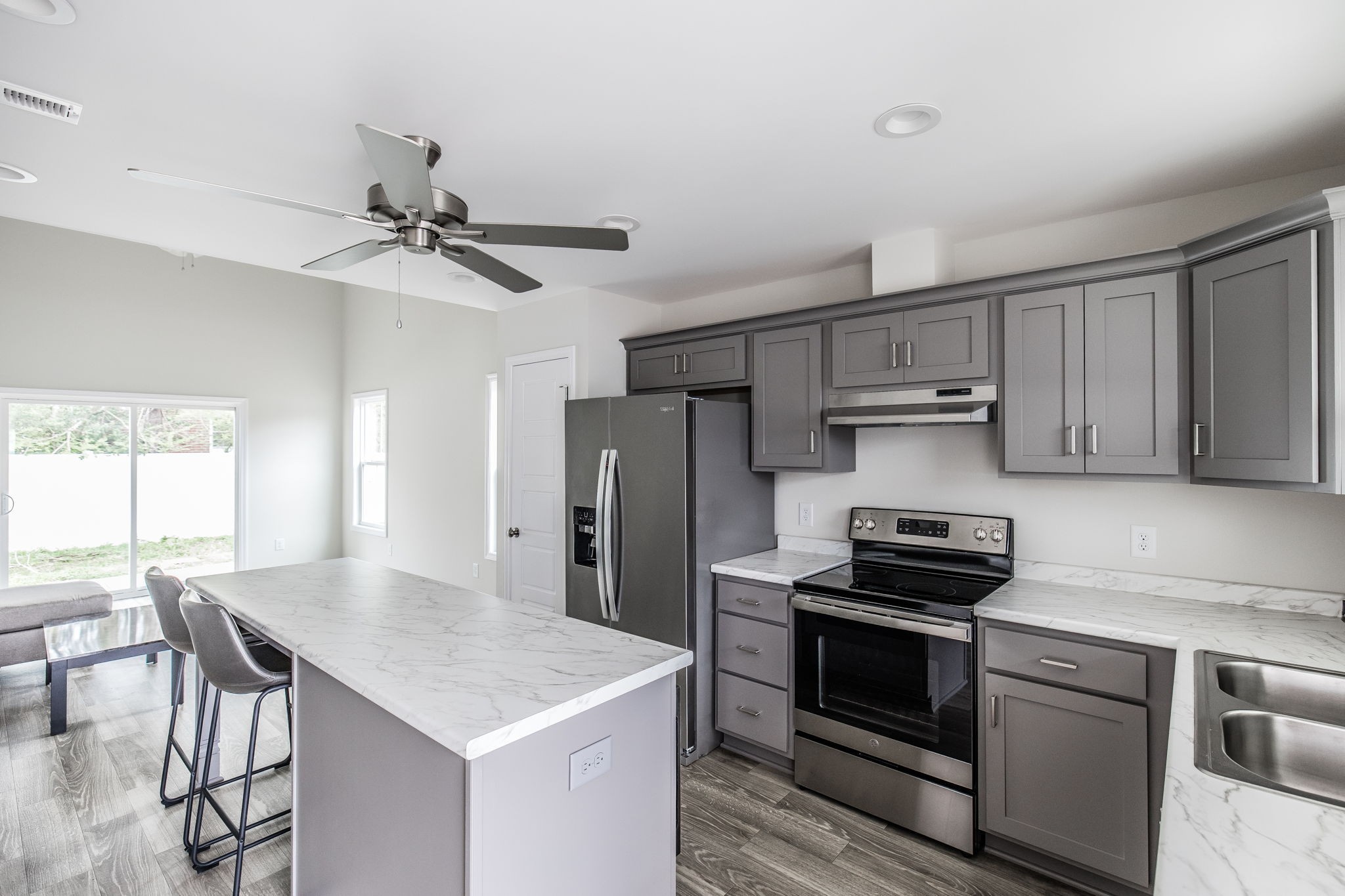 100 Billy Robb Street, Unit B Greenbrier, TN 37073 - Photo 9 of 35 a kitchen with stainless steel appliances a stove a sink dishwasher a refrigerator with a dining table and chair