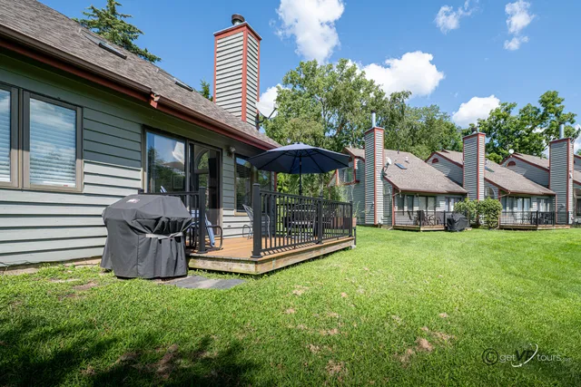 a front view of a house with a garden and outdoor seating