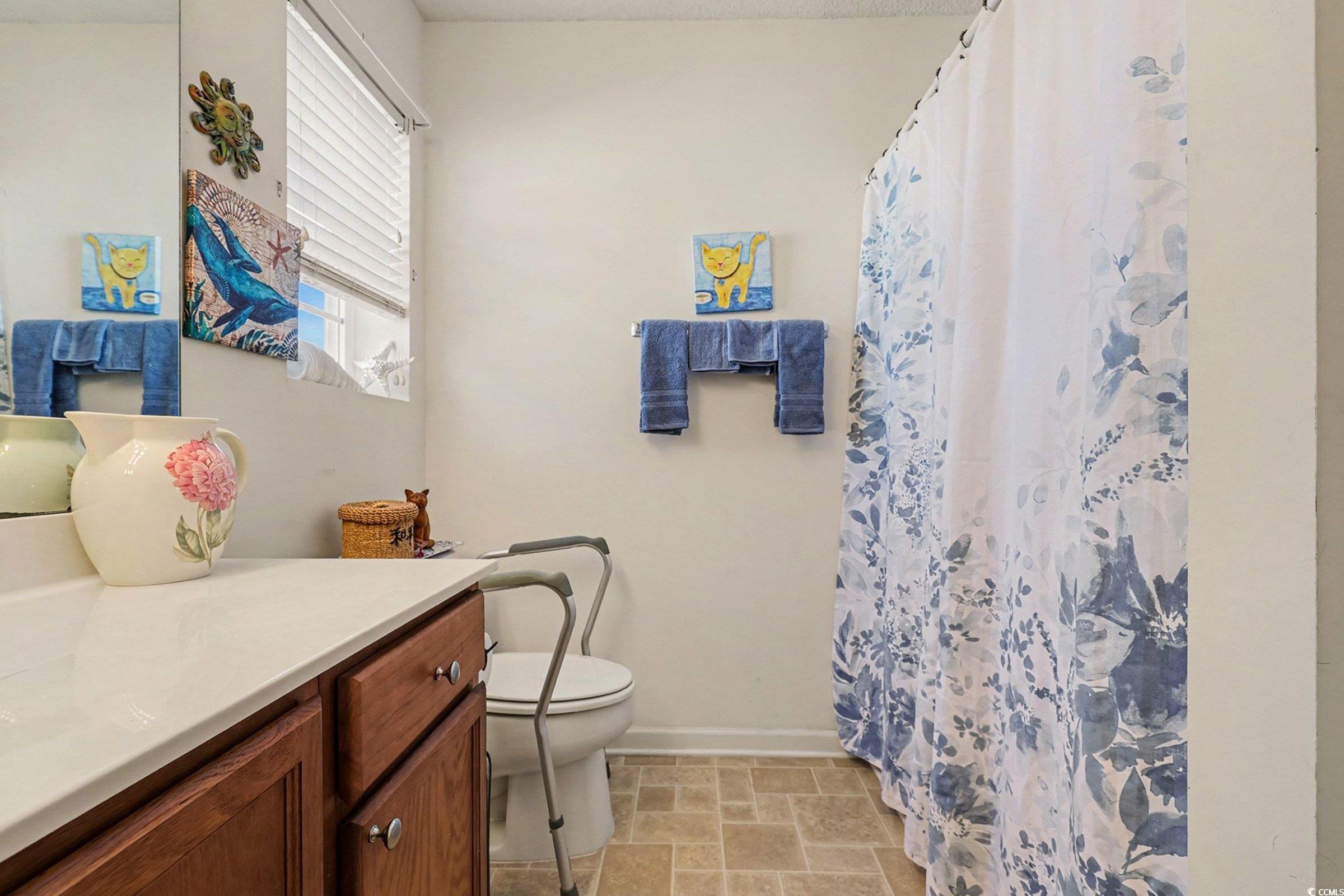 844 Sheridan Road, Unit 844 Myrtle Beach, SC 29579 - Photo 11 of 24 Full bathroom featuring curtained shower and vanity