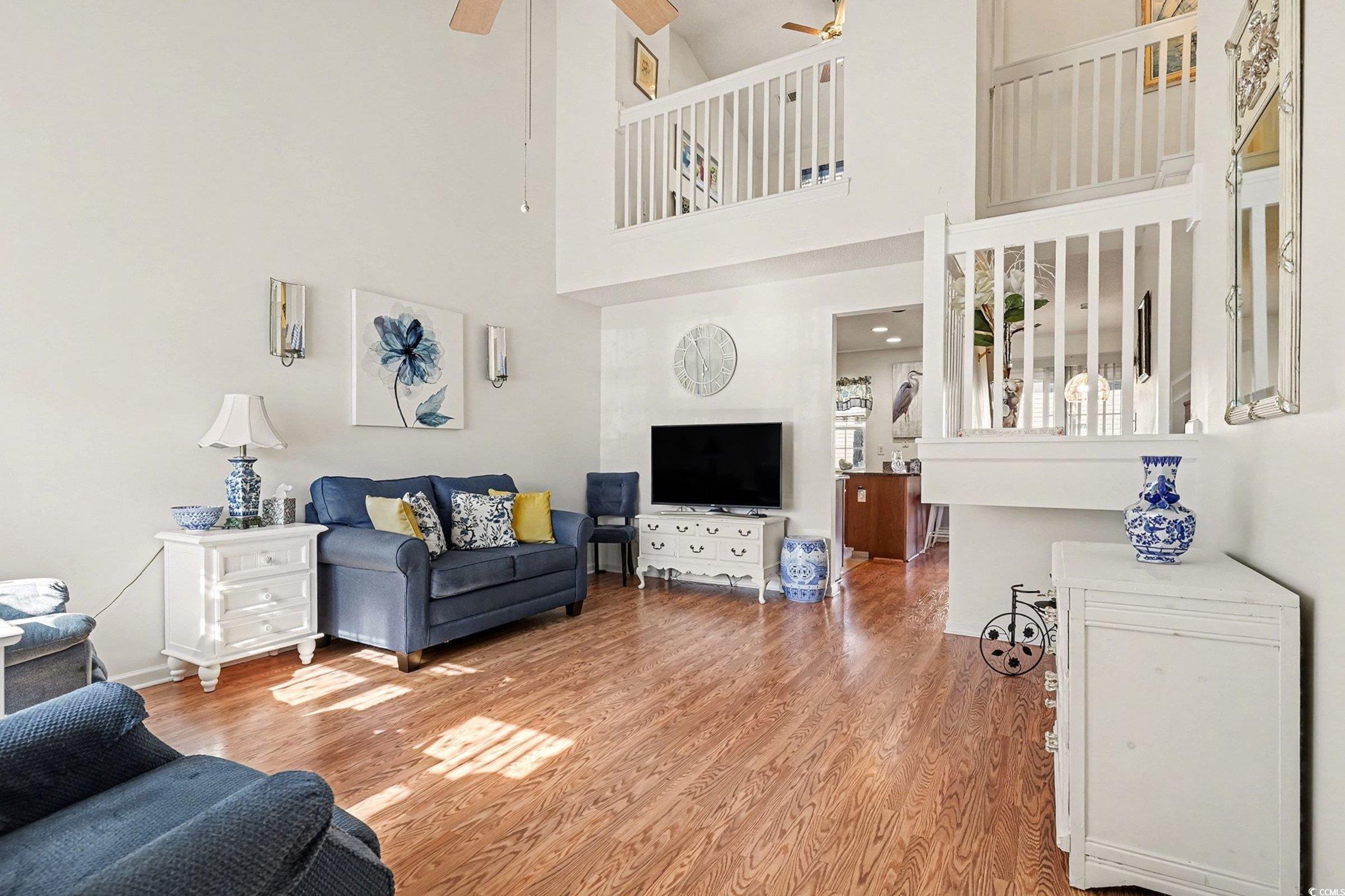 844 Sheridan Road, Unit 844 Myrtle Beach, SC 29579 - Photo 2 of 24 Living room with wood finished floors, ceiling fan, and a high ceiling