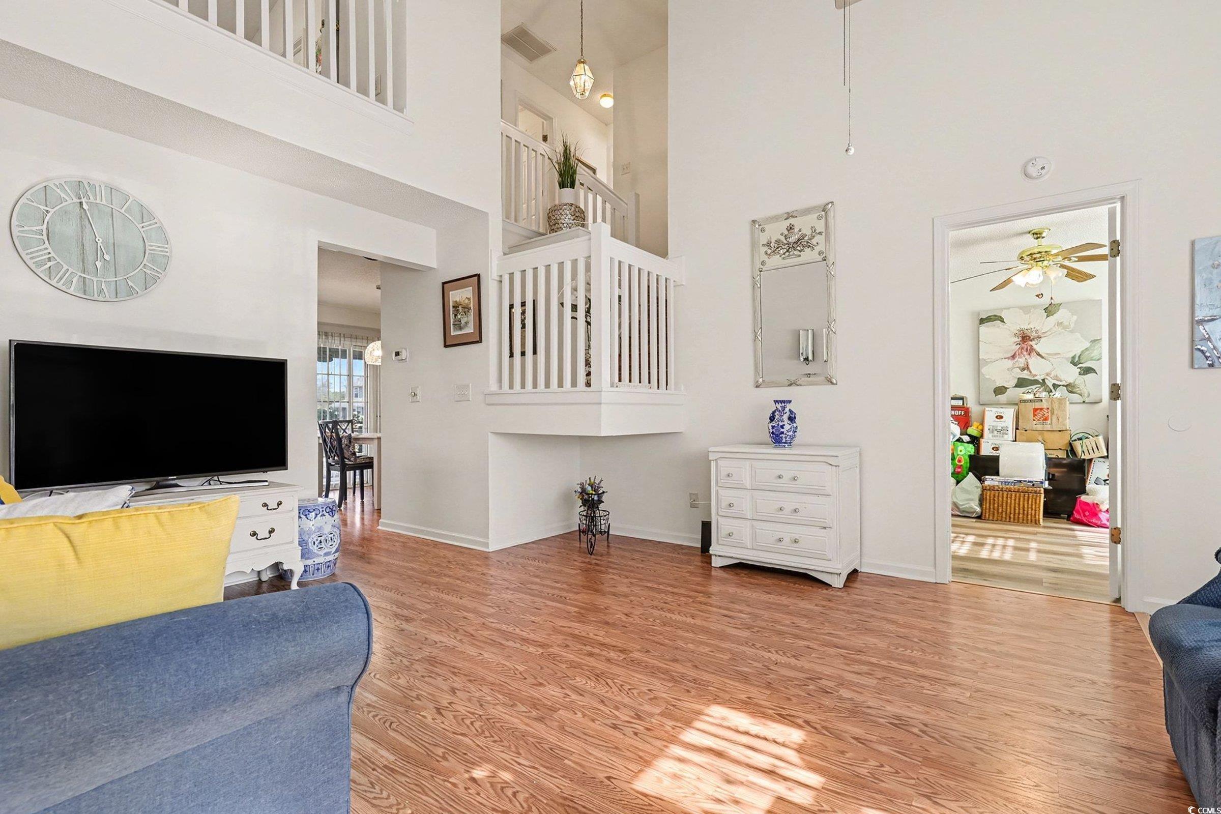 844 Sheridan Road, Unit 844 Myrtle Beach, SC 29579 - Photo 7 of 24 Living area with light wood-style flooring, a ceiling fan, and a towering ceiling