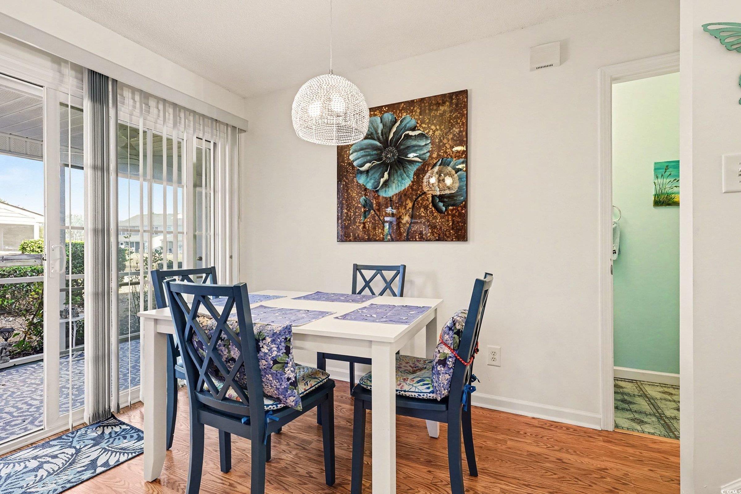 844 Sheridan Road, Unit 844 Myrtle Beach, SC 29579 - Photo 8 of 24 Dining room featuring light wood-style floors and a chandelier