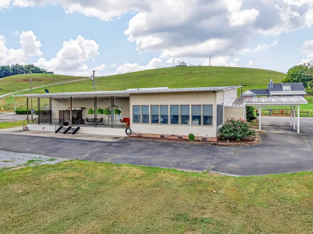 a view of a roof deck with table and chairs and wooden floor