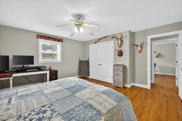 a bathroom with a granite countertop sink a toilet and a mirror