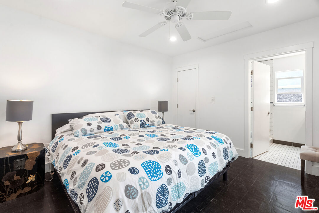 430 Rialto Avenue Venice, CA 90291 - Photo 14 of 23 a bedroom with a bed and a chandelier