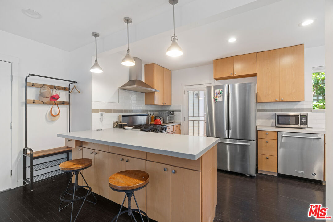 430 Rialto Avenue Venice, CA 90291 - Photo 10 of 23 a kitchen with stainless steel appliances granite countertop a refrigerator a sink dishwasher a stove and white cabinets with wooden floor