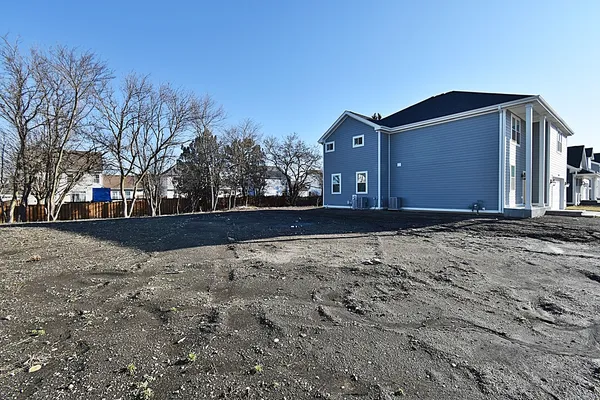 a view of a yard with a house in the background