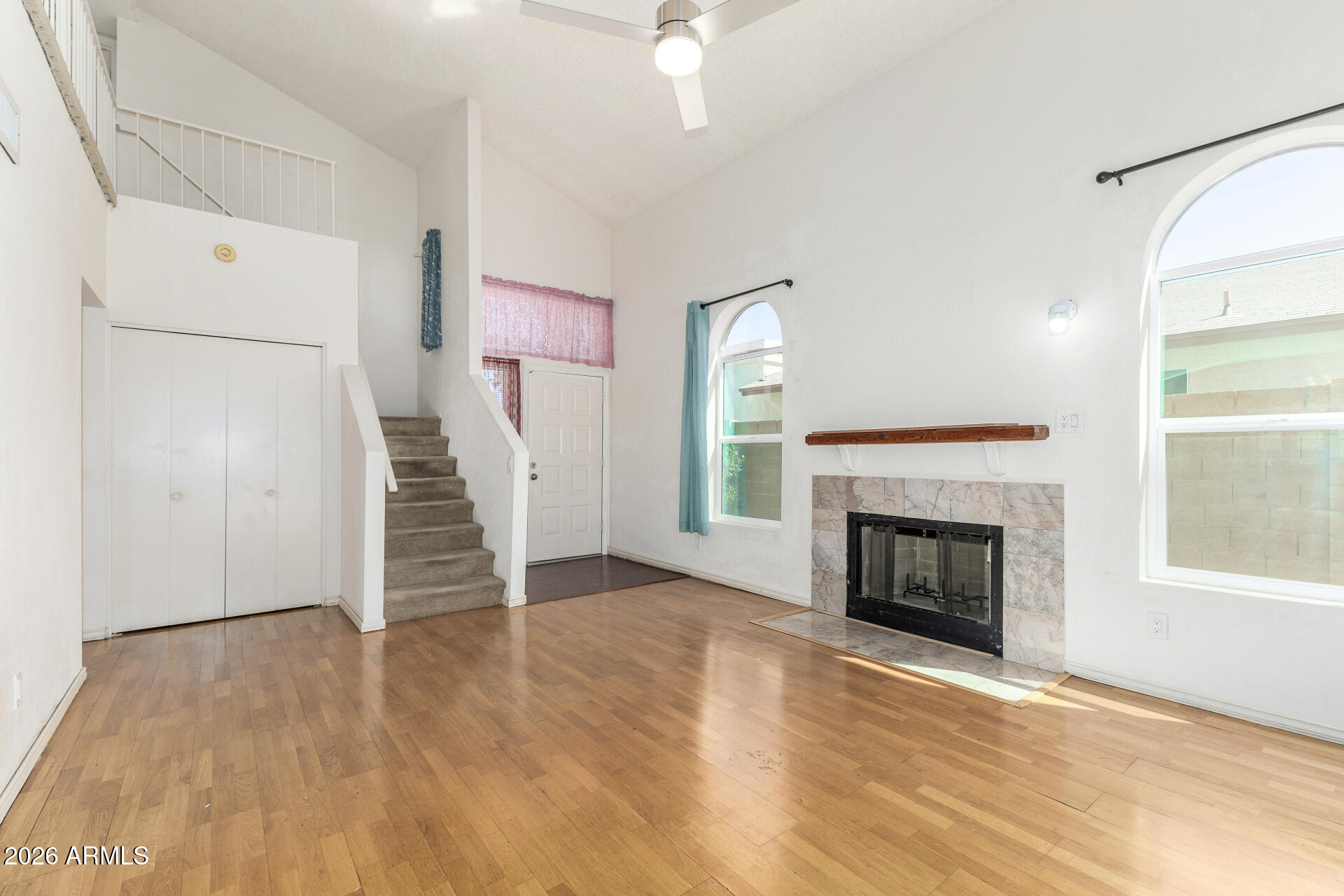 4741 West Marco Polo Road Glendale, AZ 85308 - Photo 7 of 32 an empty room with wooden floor fireplace and windows
