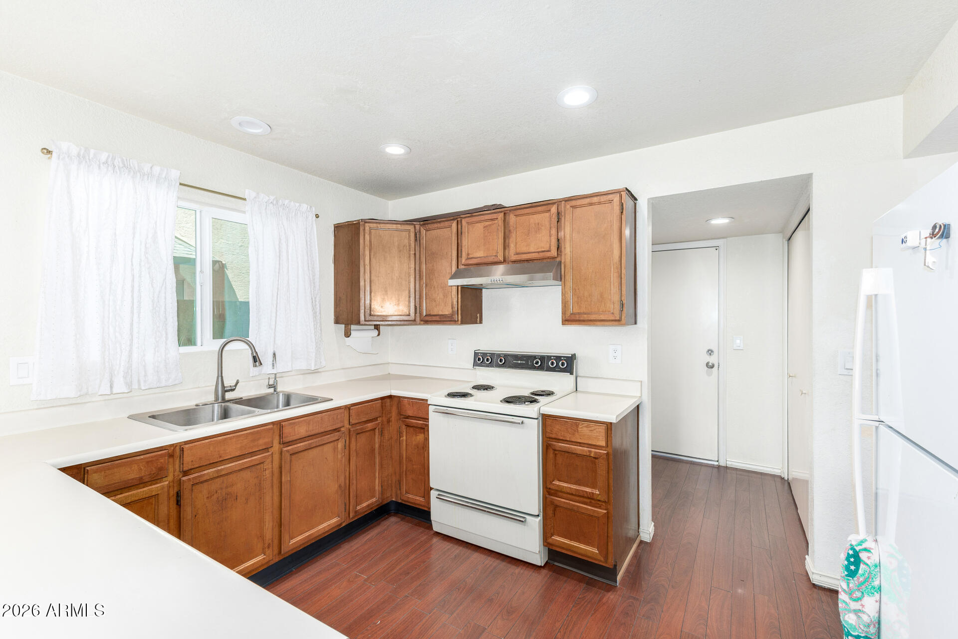 4741 West Marco Polo Road Glendale, AZ 85308 - Photo 10 of 32 a kitchen with a sink stove and cabinets