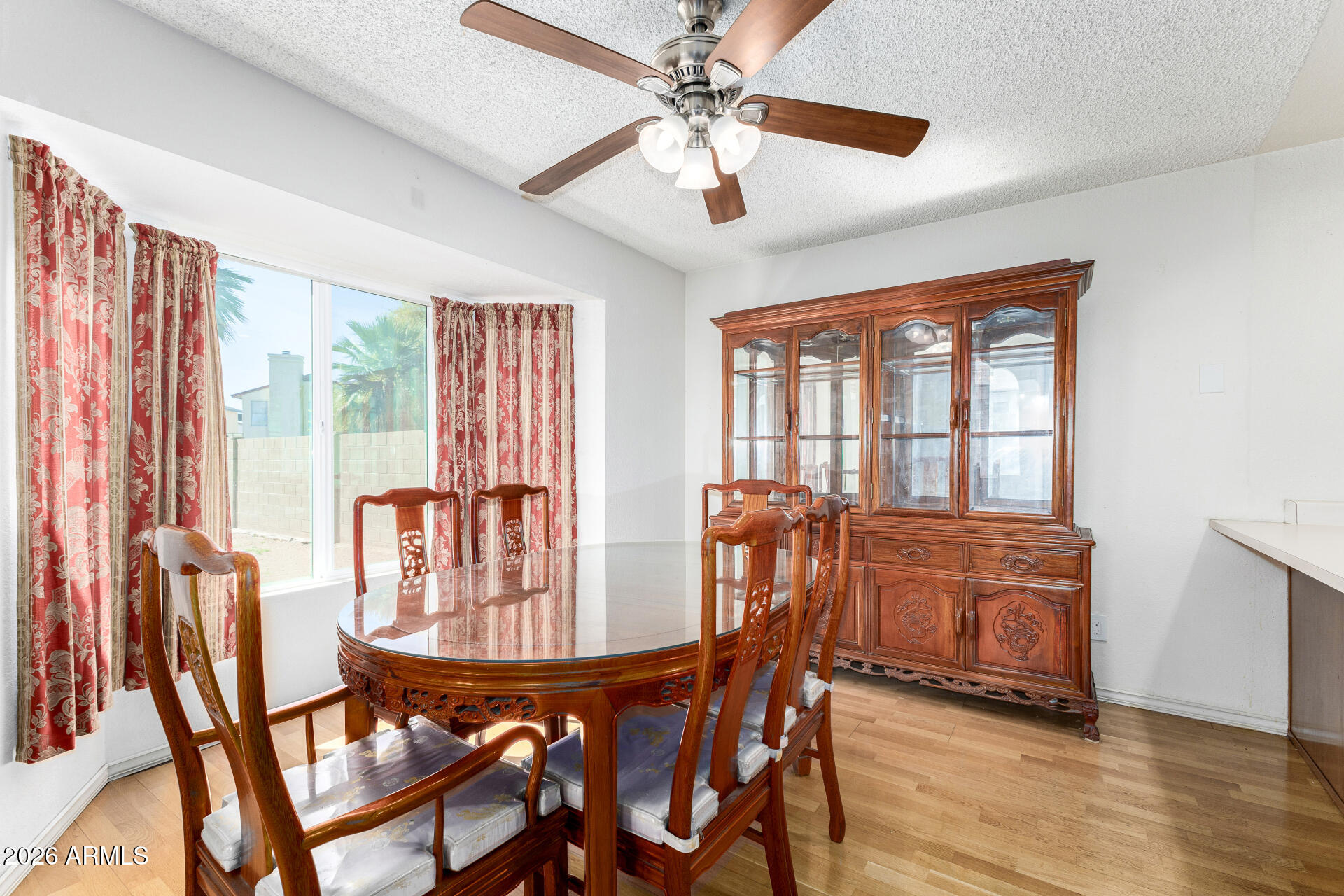 4741 West Marco Polo Road Glendale, AZ 85308 - Photo 11 of 32 a view of a dining room with furniture window and wooden floor