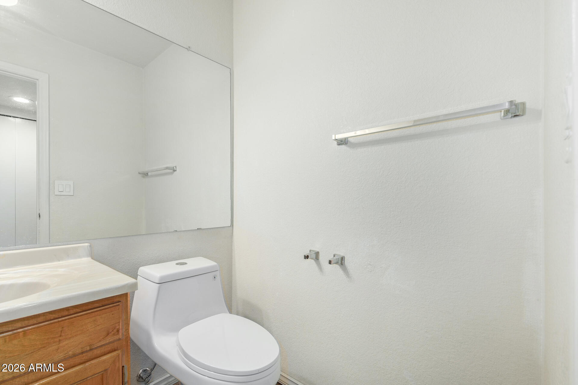 4741 West Marco Polo Road Glendale, AZ 85308 - Photo 12 of 32 a white toilet sitting next to a shower