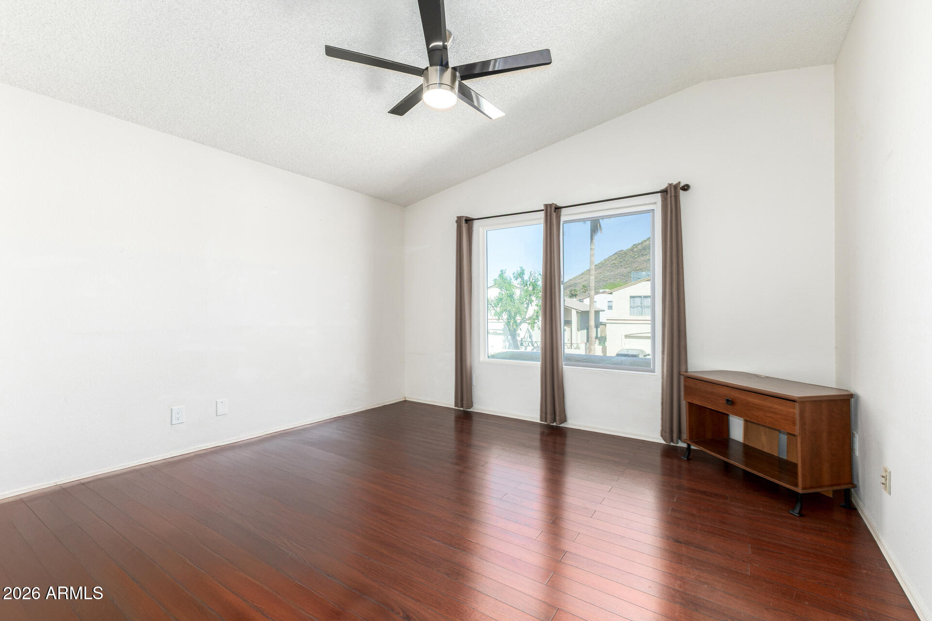 4741 West Marco Polo Road Glendale, AZ 85308 - Photo 13 of 32 a view of an empty room with wooden floor and a window