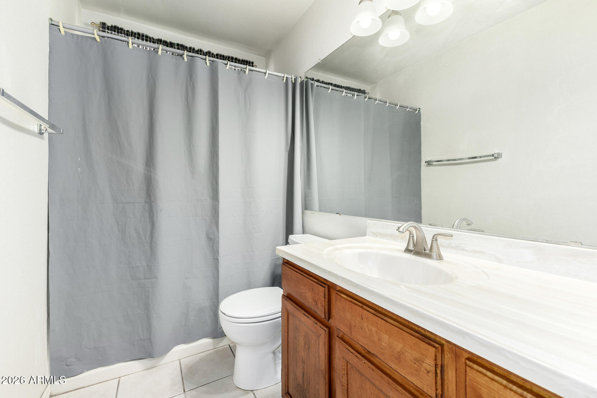 4741 West Marco Polo Road Glendale, AZ 85308 - Photo 18 of 32 a bathroom with a sink a toilet a mirror and shower curtain