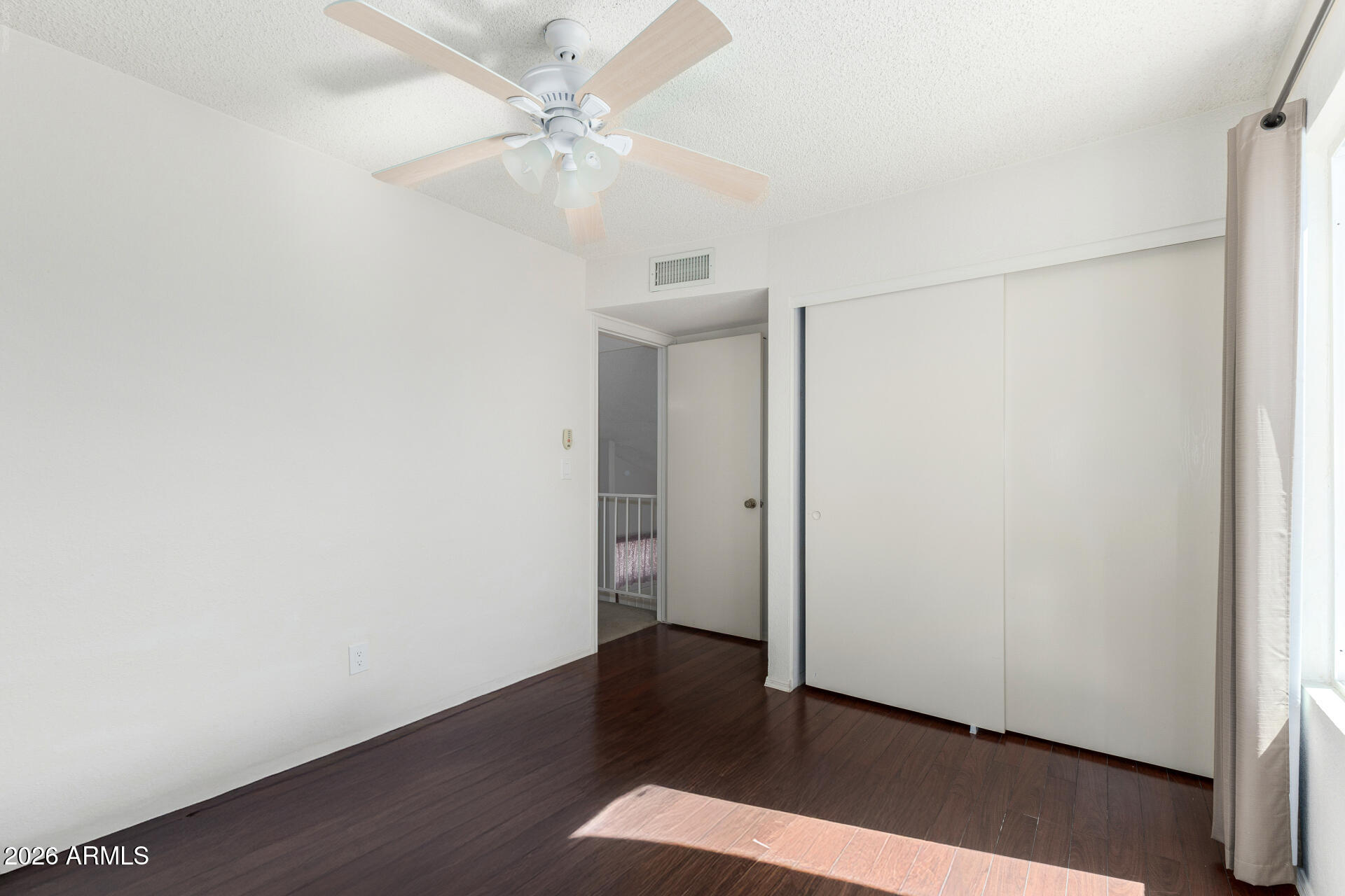 4741 West Marco Polo Road Glendale, AZ 85308 - Photo 20 of 32 an empty room with wooden floor and fan