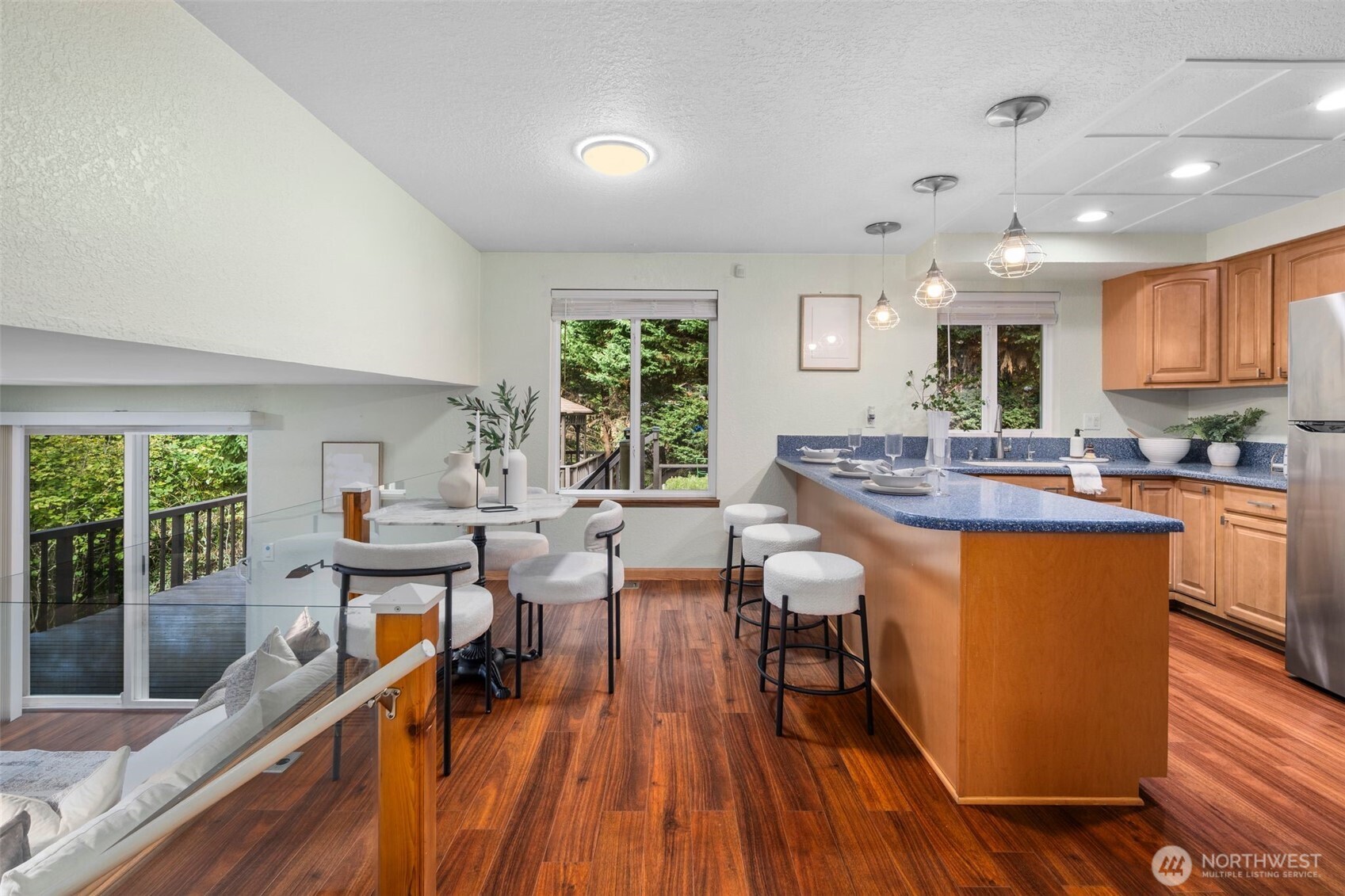 18016 Southeast 147th Street Renton, WA 98059 - Photo 6 of 38 a kitchen with stainless steel appliances granite countertop wooden floors stove sink and cabinets