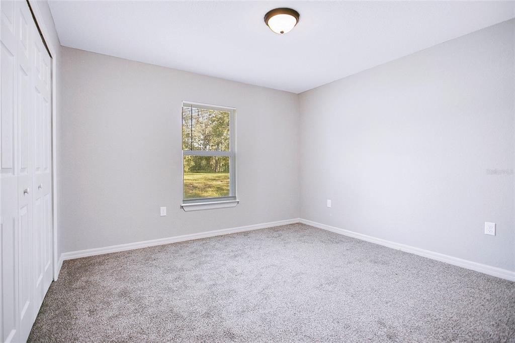 6949 Southwest 152nd Street Ocala, FL 34473 - Photo 12 of 20 an empty room with a window