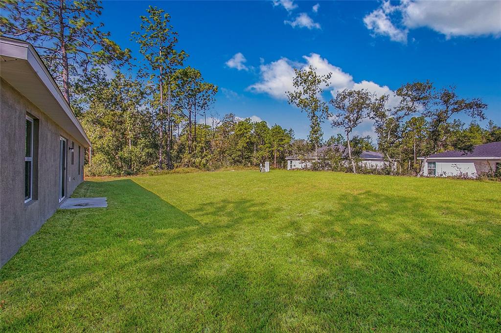6949 Southwest 152nd Street Ocala, FL 34473 - Photo 15 of 20 a view of a house with a yard