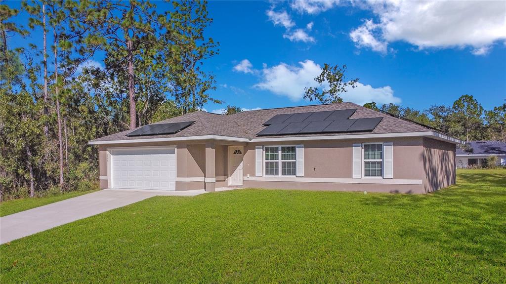 6949 Southwest 152nd Street Ocala, FL 34473 - Photo 2 of 20 a front view of a house with a garden