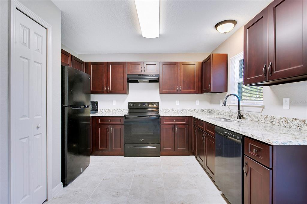 6949 Southwest 152nd Street Ocala, FL 34473 - Photo 7 of 20 a kitchen with a sink a stove and refrigerator