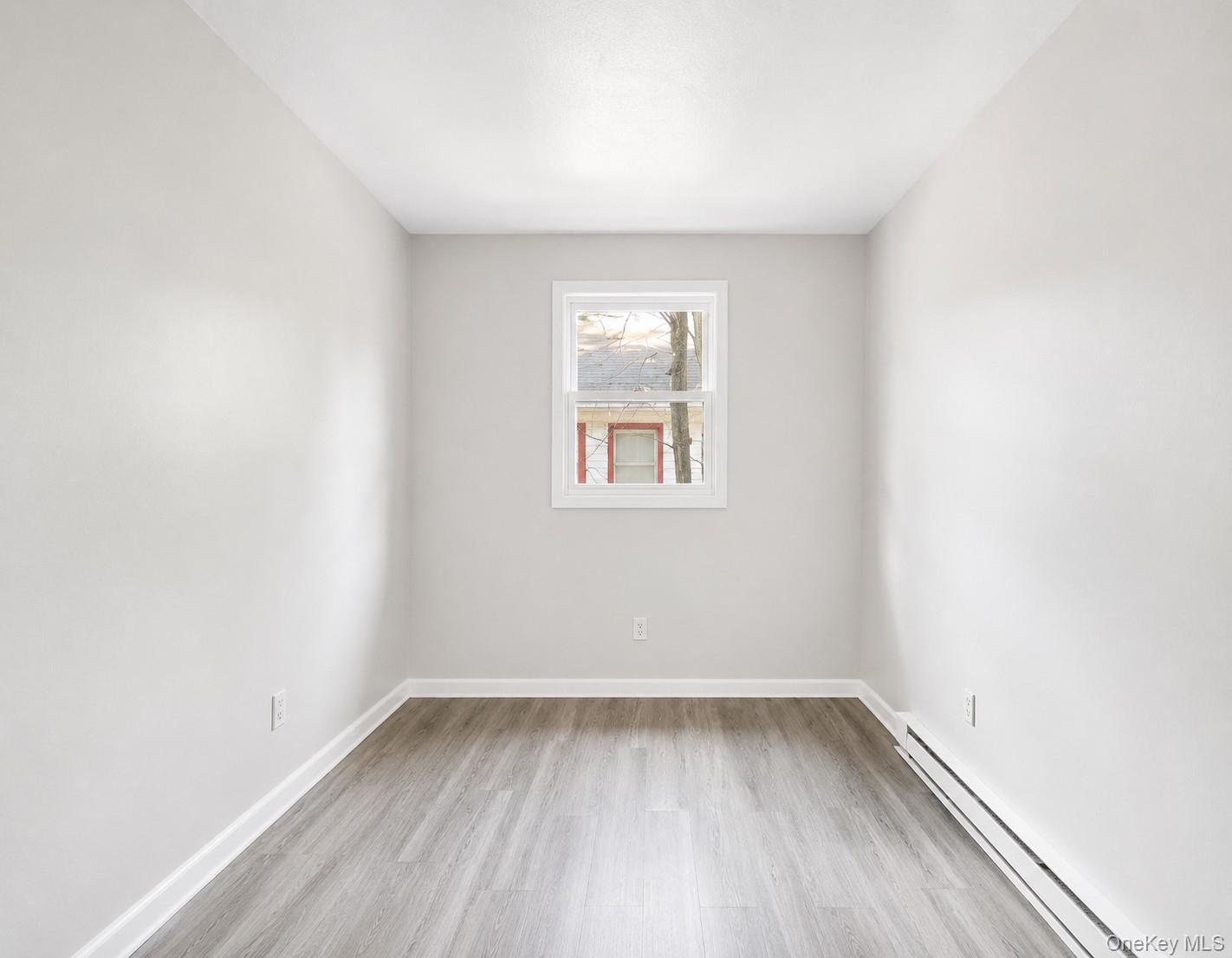 55 Hasbrouck A Road Fallsburg, NY 12759 - Photo 5 of 8 wooden floor in an empty room with a window