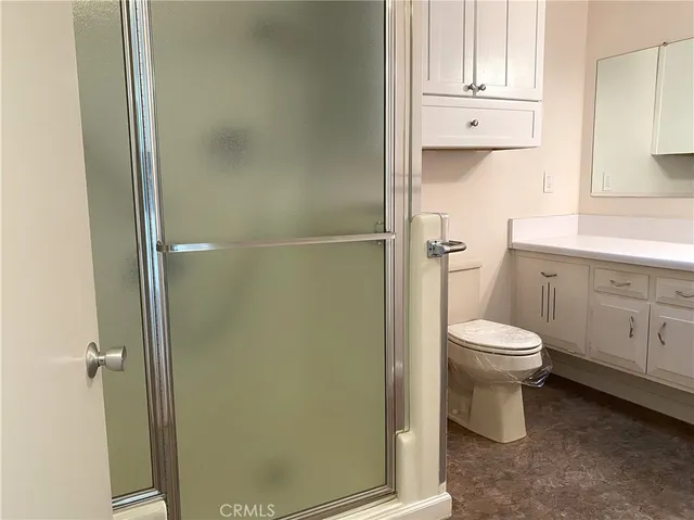 a bathroom with a toilet a sink and shower