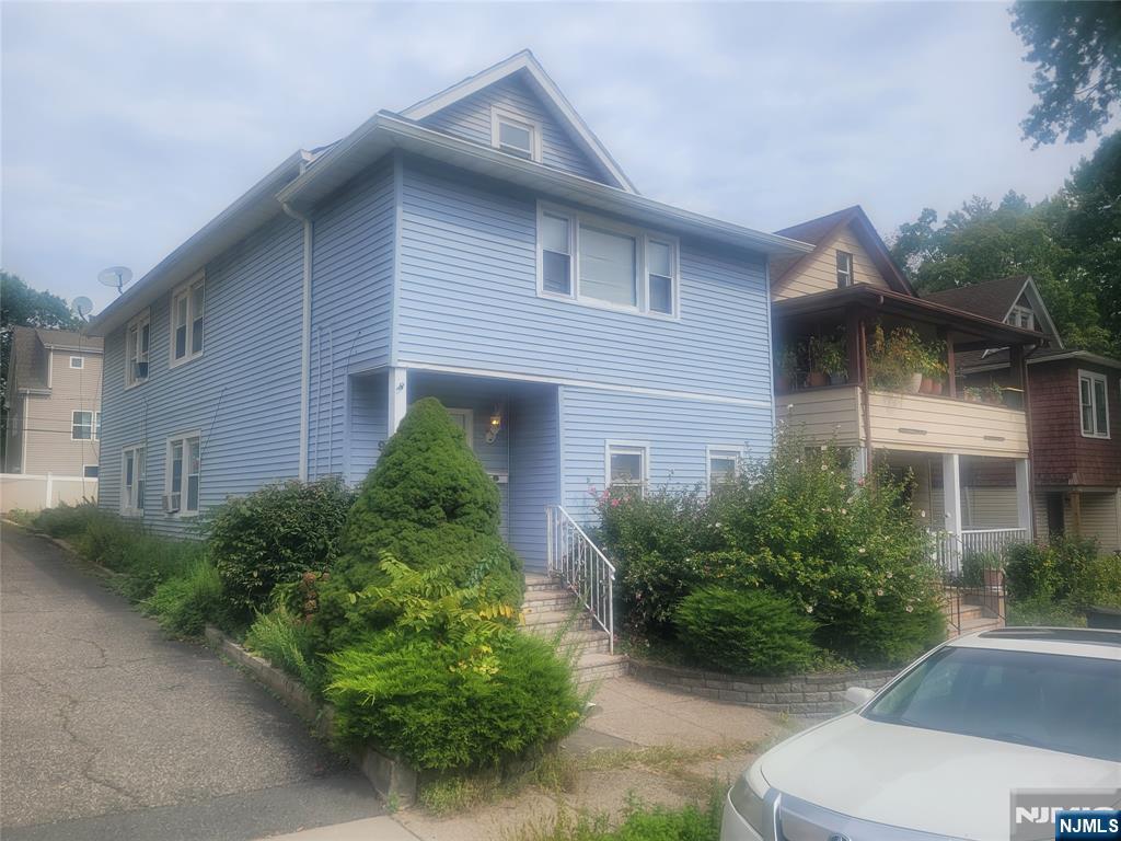 a front view of a house with garden