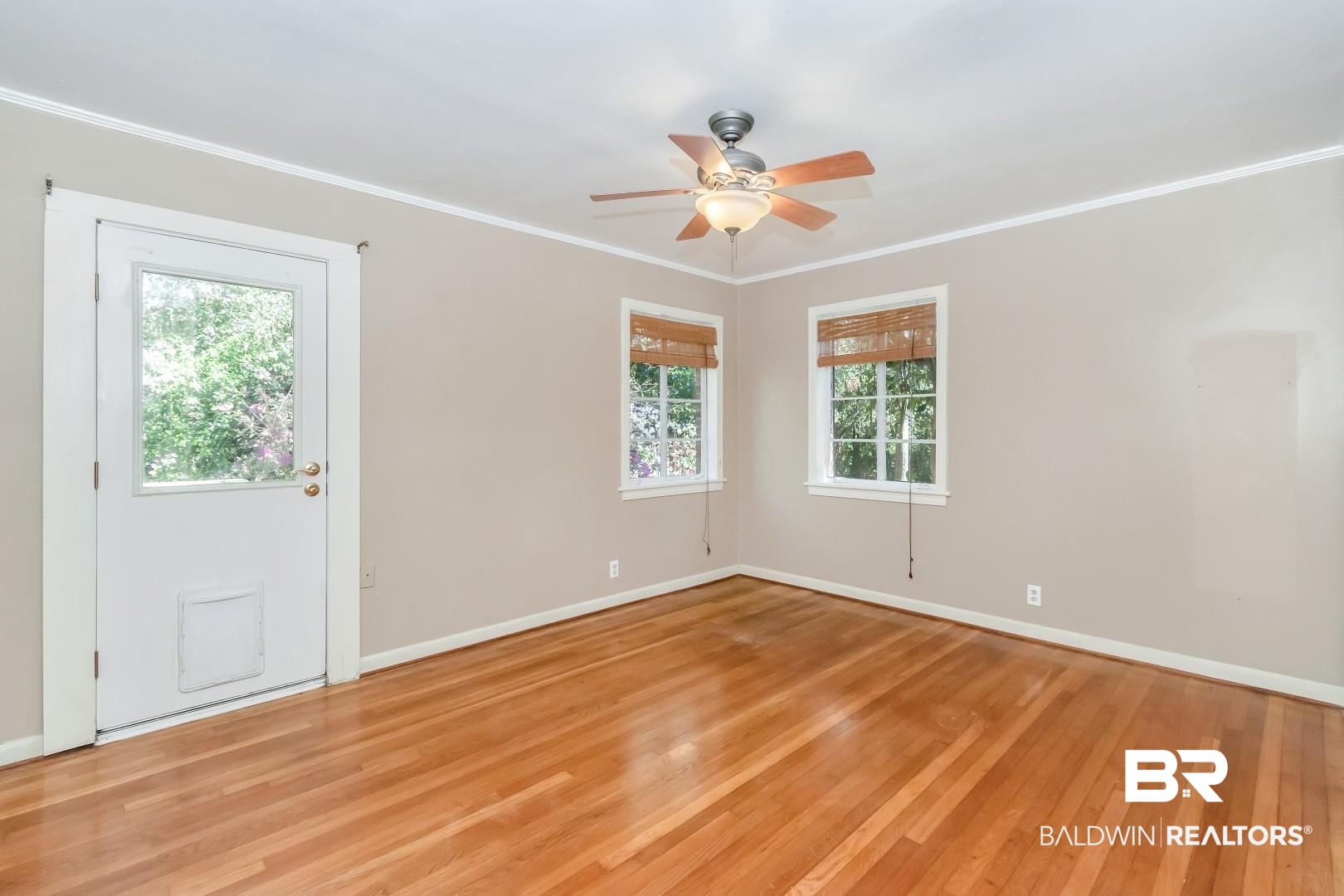 419 Ridgecrest Court Mobile, AL 36609 - Photo 14 of 20 Unfurnished room featuring light wood-type flooring, baseboards, ceiling fan, and crown molding