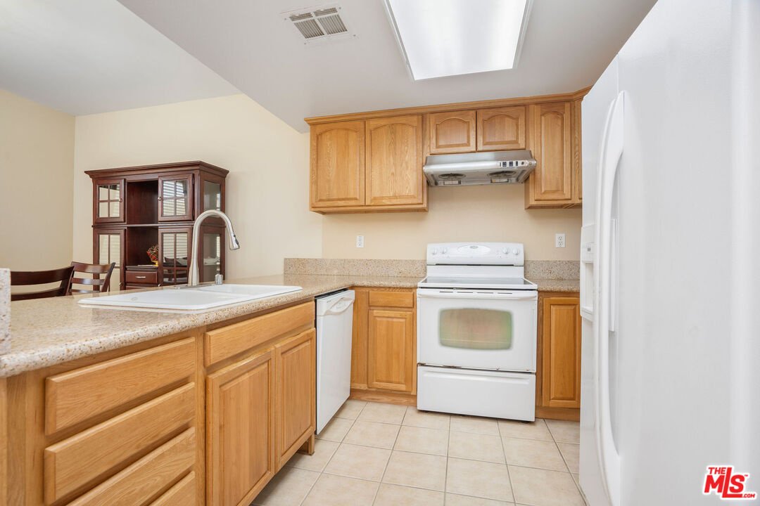 1128 West Duarte Road, Unit A Arcadia, CA 91007 - Photo 13 of 28 a kitchen with stainless steel appliances granite countertop a sink and cabinets