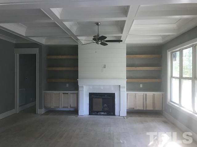 5000 Fanyon Way Raleigh, NC 27612 - Photo 6 of 25 Open concept with floting built in cabinets for storage and wood floating shelves. Gas fireplace w/ blower. Custom surround with shiplap accents and wood mantle!