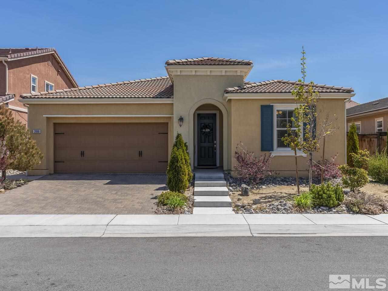 2090 Tawleed Road Reno, NV 89521 - Photo 1 of 24 a front view of a house with a yard and garage