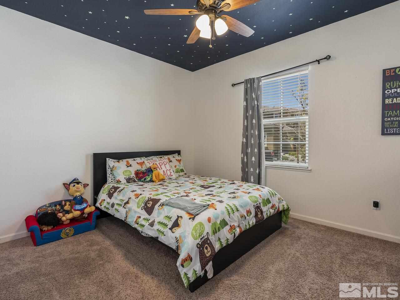 2090 Tawleed Road Reno, NV 89521 - Photo 15 of 24 a bedroom with a bed and a chandelier