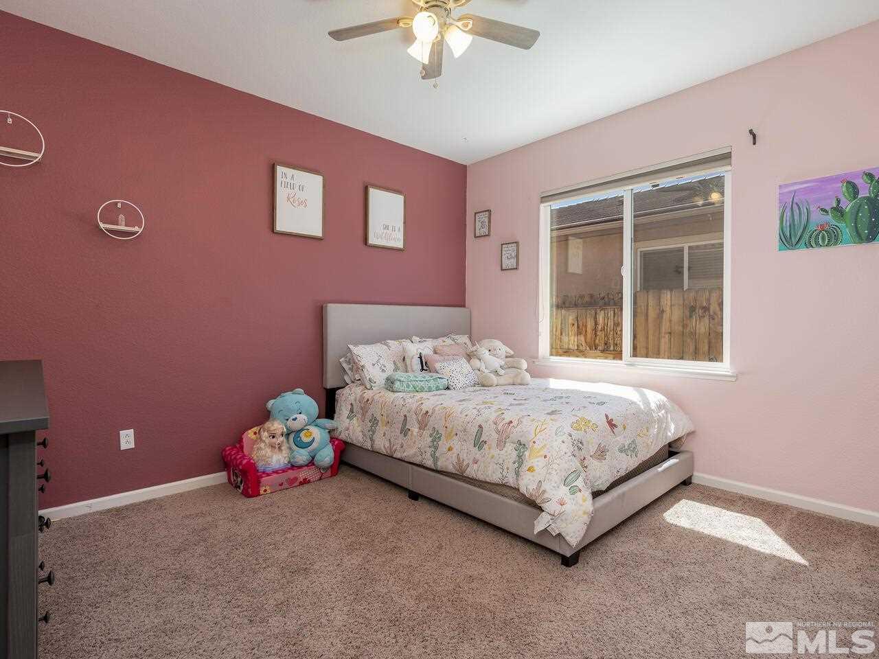 2090 Tawleed Road Reno, NV 89521 - Photo 16 of 24 a bedroom with a bed and a chandelier