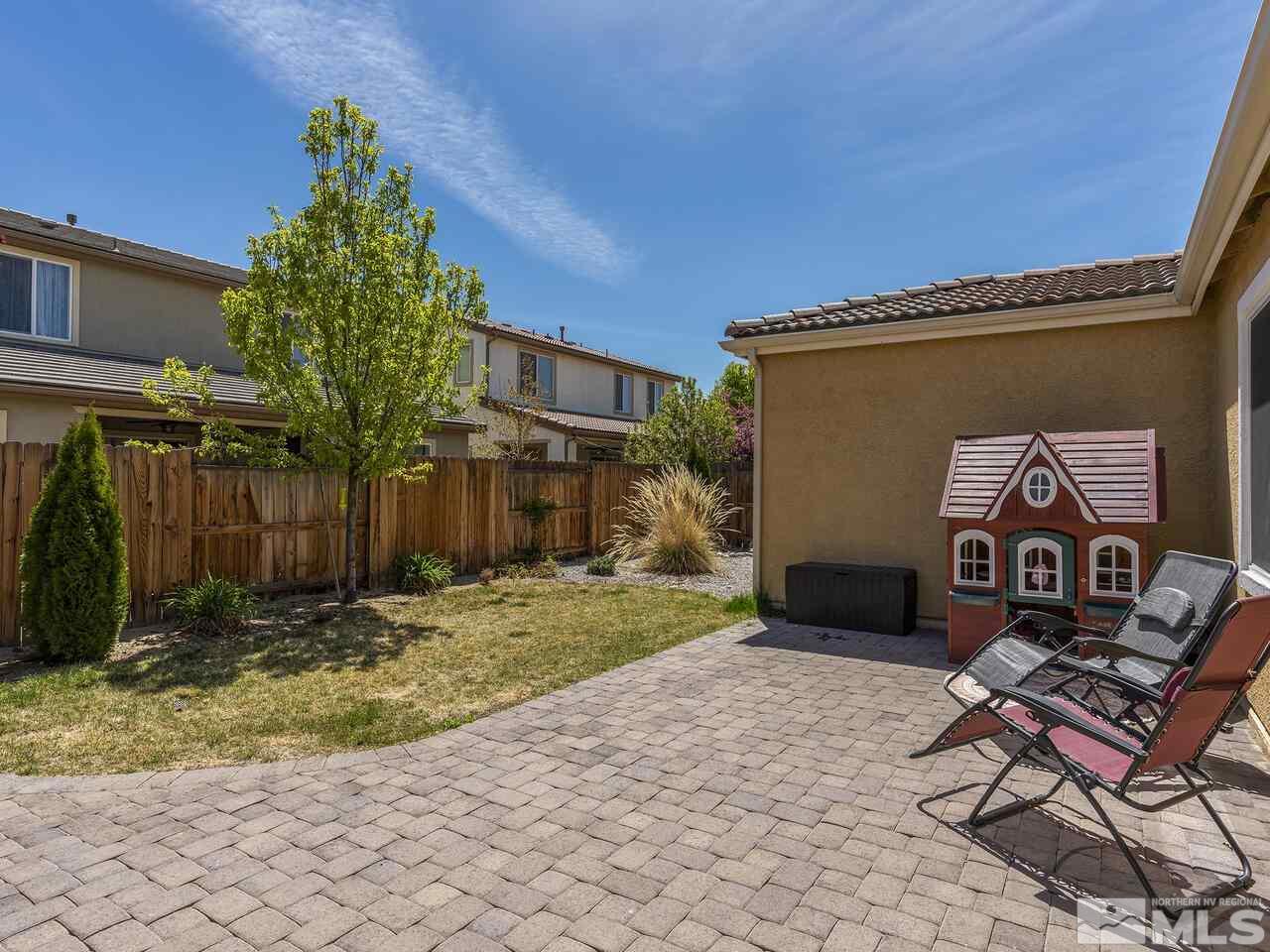 2090 Tawleed Road Reno, NV 89521 - Photo 18 of 24 a backyard of a house with yard and outdoor seating