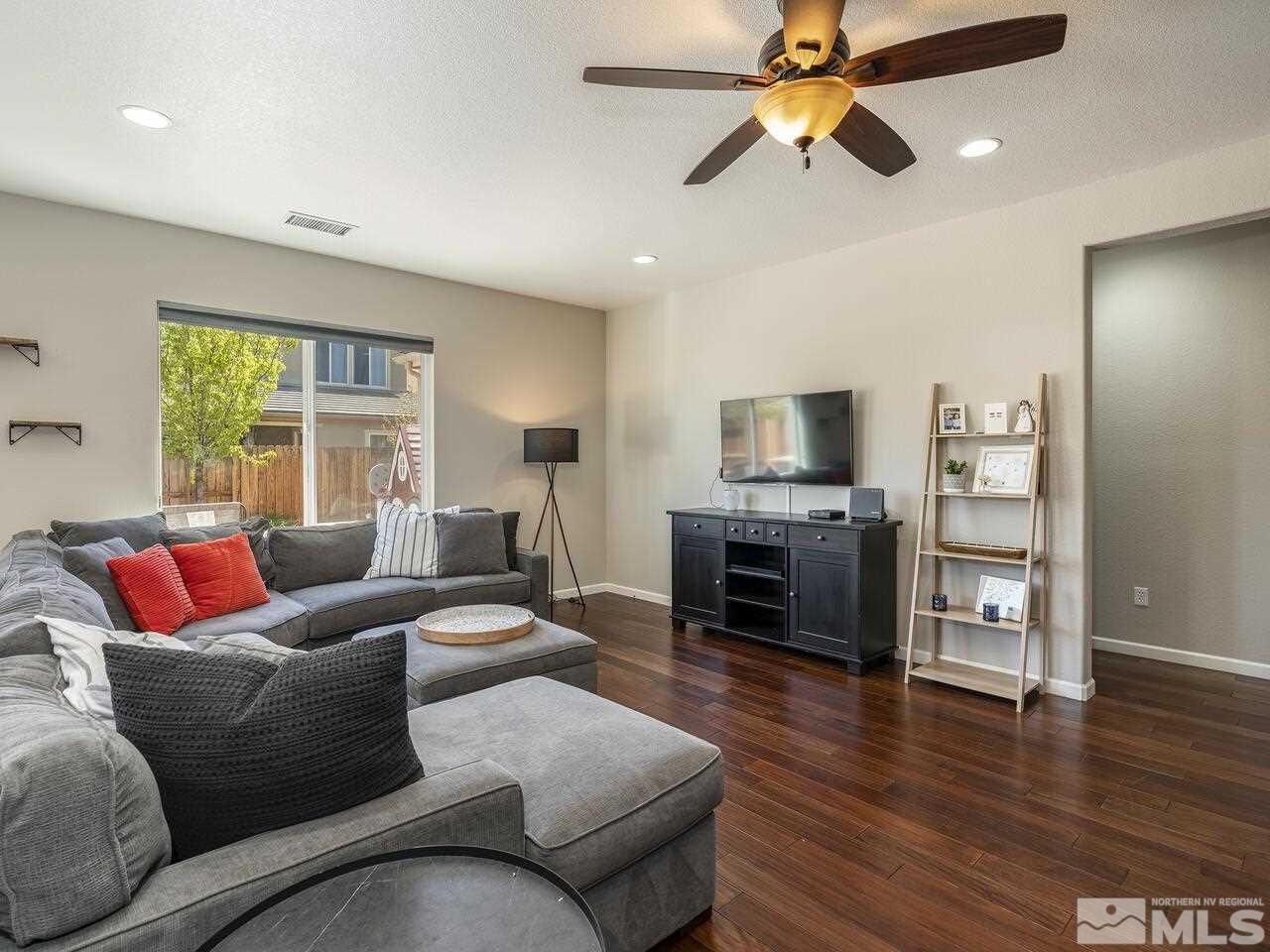 2090 Tawleed Road Reno, NV 89521 - Photo 5 of 24 a living room with furniture a fireplace and a flat screen tv