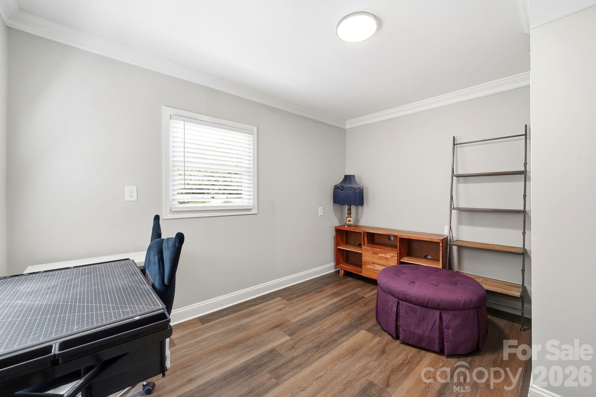 7552 Idlewild Road Charlotte, NC 28212 - Photo 22 of 40 a room with furniture and wooden floor