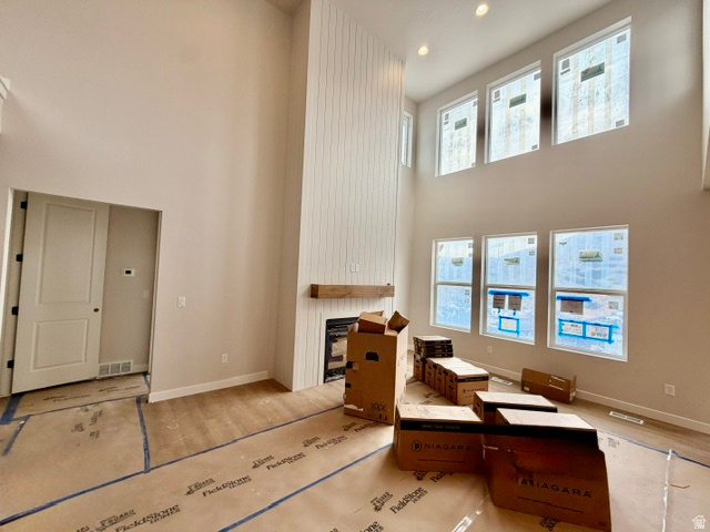 5885 Canyon Rim Road, Unit 624 Lehi, UT 84048 - Photo 4 of 10 Two-story living area featuring a floor-to-ceiling fireplace with vertical shiplap detailing and a wood mantel