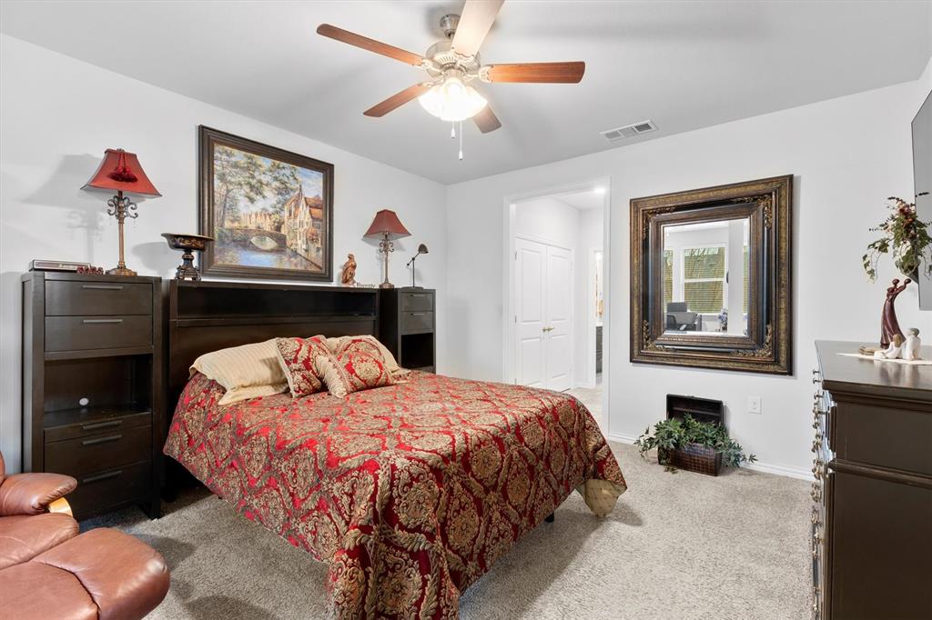 651 Watters Road, Unit 5205 Allen, TX 75013 - Photo 10 of 31 a bedroom with a bed and a chandelier
