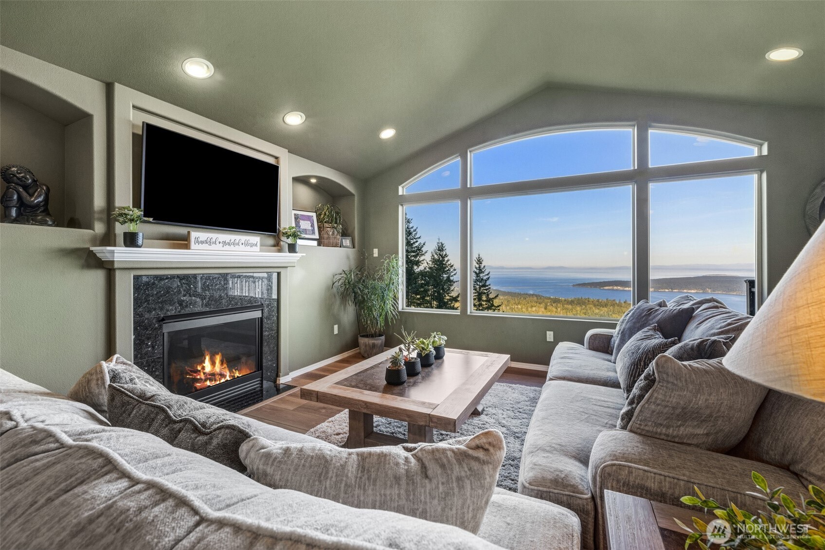 855 Louella Heights Road Sequim, WA 98382 - Photo 12 of 40 a living room with furniture fireplace and flat screen tv