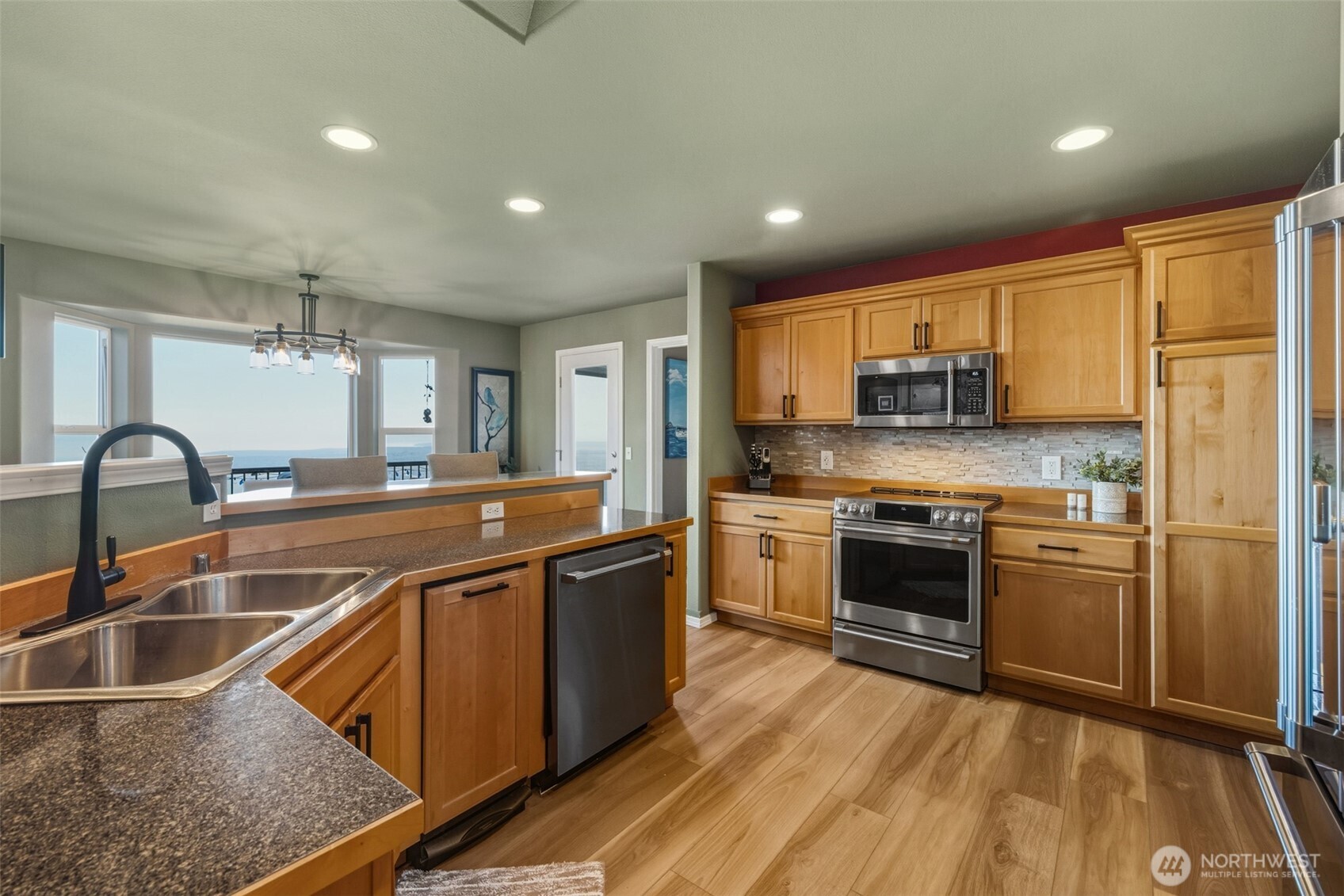 855 Louella Heights Road Sequim, WA 98382 - Photo 13 of 40 a kitchen with stainless steel appliances granite countertop a sink stove and refrigerator