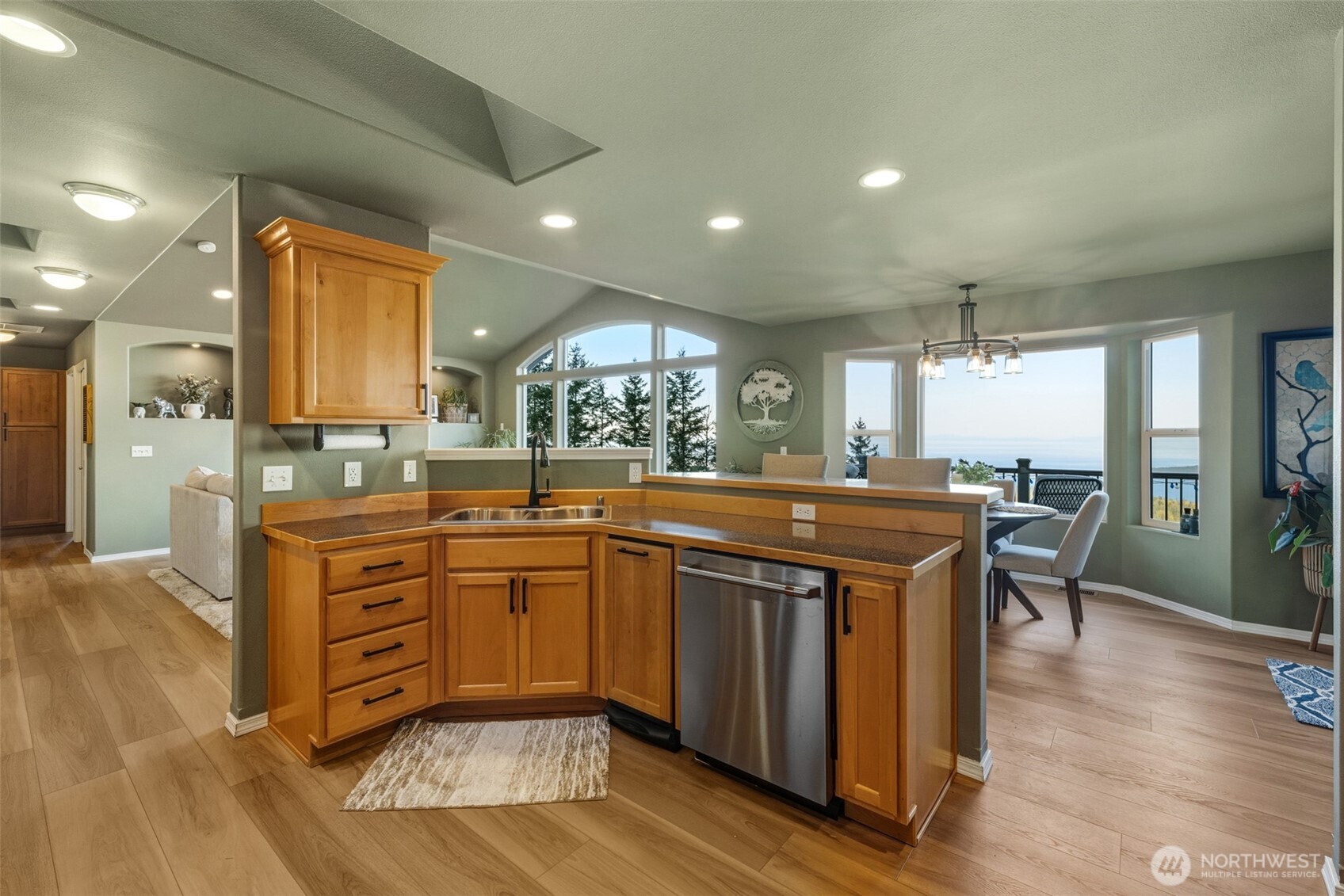 855 Louella Heights Road Sequim, WA 98382 - Photo 15 of 40 a kitchen with stainless steel appliances granite countertop a stove and a wooden floors