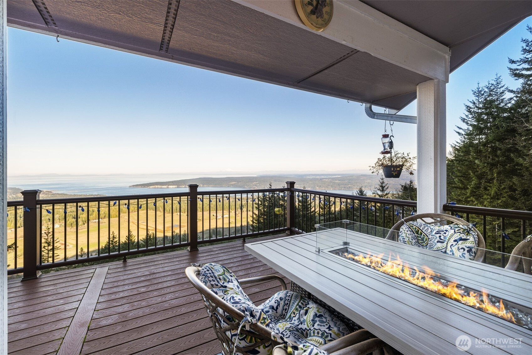 855 Louella Heights Road Sequim, WA 98382 - Photo 19 of 40 a balcony with wooden floor table and chairs