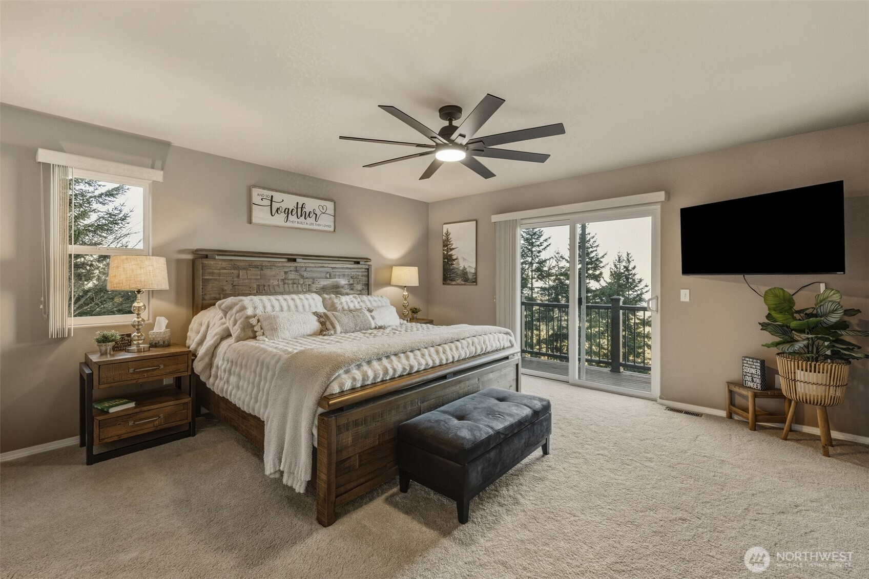 855 Louella Heights Road Sequim, WA 98382 - Photo 21 of 40 a spacious bedroom with a bed and a flat screen tv