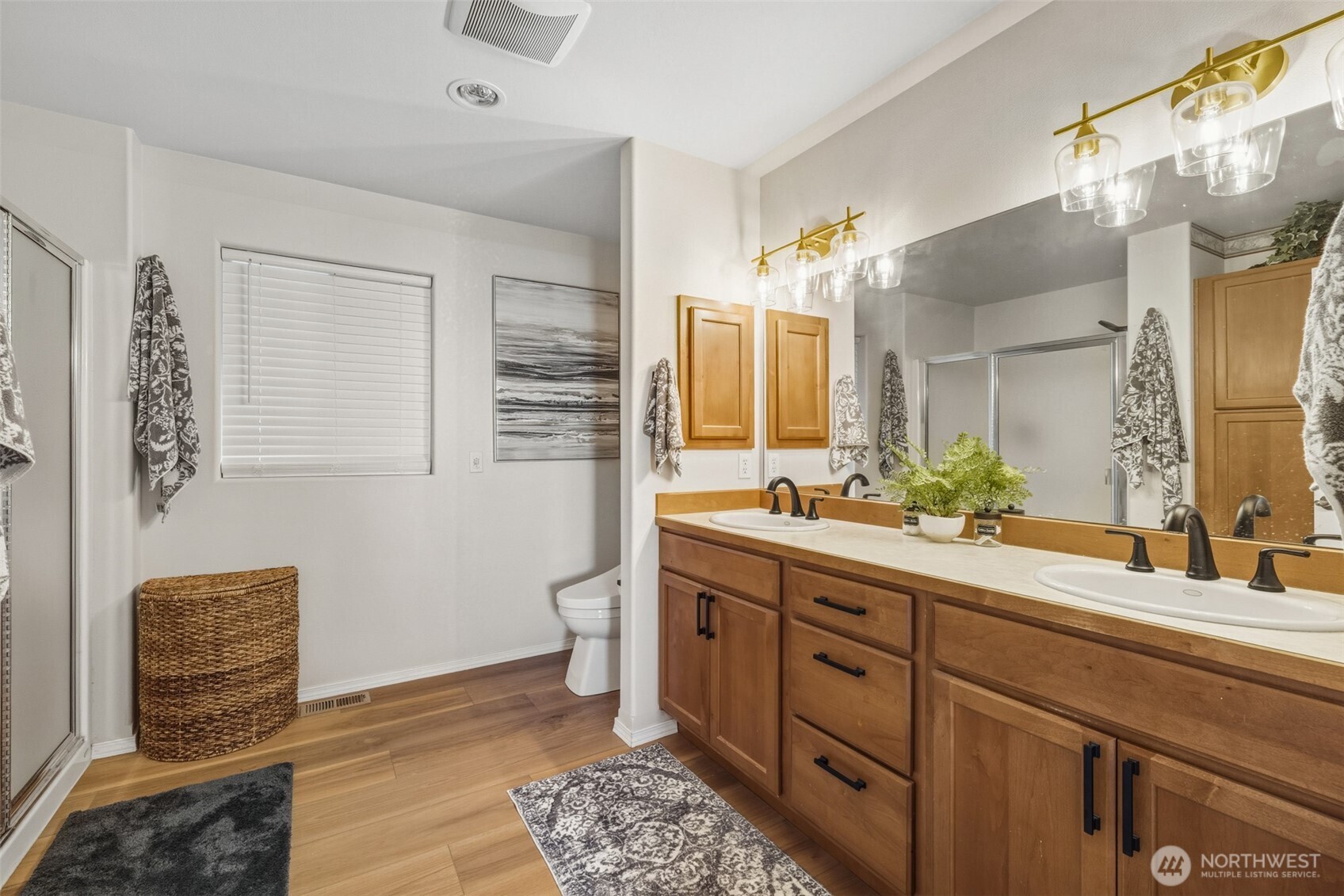 855 Louella Heights Road Sequim, WA 98382 - Photo 24 of 40 a spacious bathroom with a double vanity sink a mirror a and a toilet