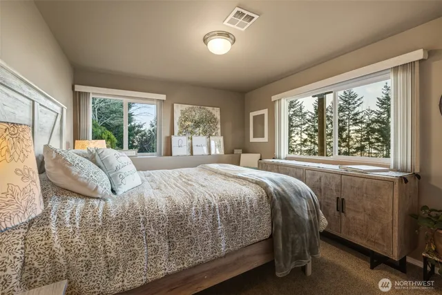 a bed sitting in a bedroom next to a window