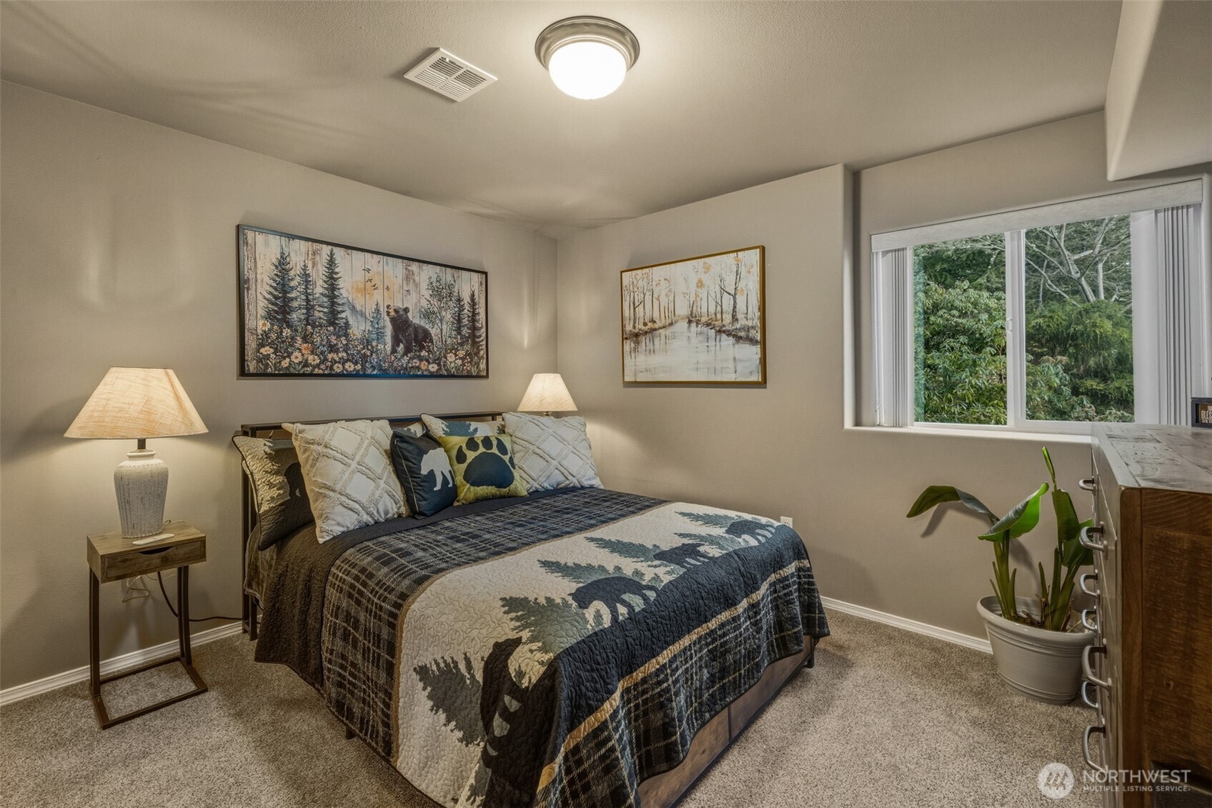 855 Louella Heights Road Sequim, WA 98382 - Photo 29 of 40 a bedroom with a bed and a painting on the wall