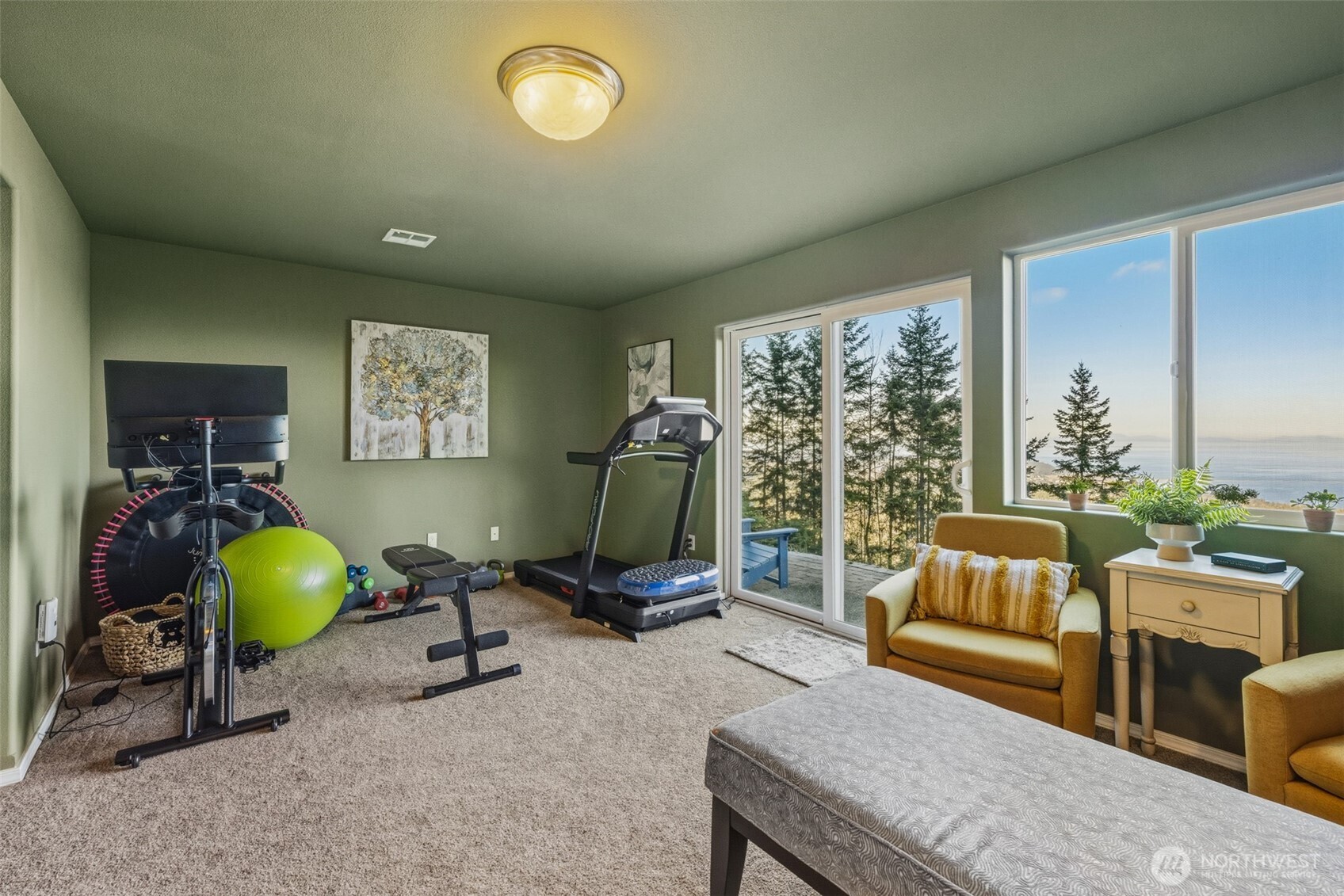 855 Louella Heights Road Sequim, WA 98382 - Photo 36 of 40 a living room with furniture gym equipment and a large window